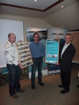 Nationalparkamtsmitarbeiter Martin Kaiser (li.) und Amtsleiter Ulrich Meßner (re.) übergeben Visitenkarten-Kästen an Ingo Hecht von der Firma Nationalpark-Tour, Dalmsdorf